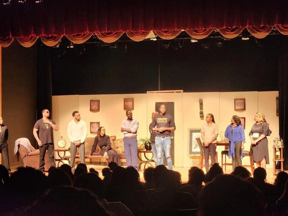 Cast gathered on stage during a production